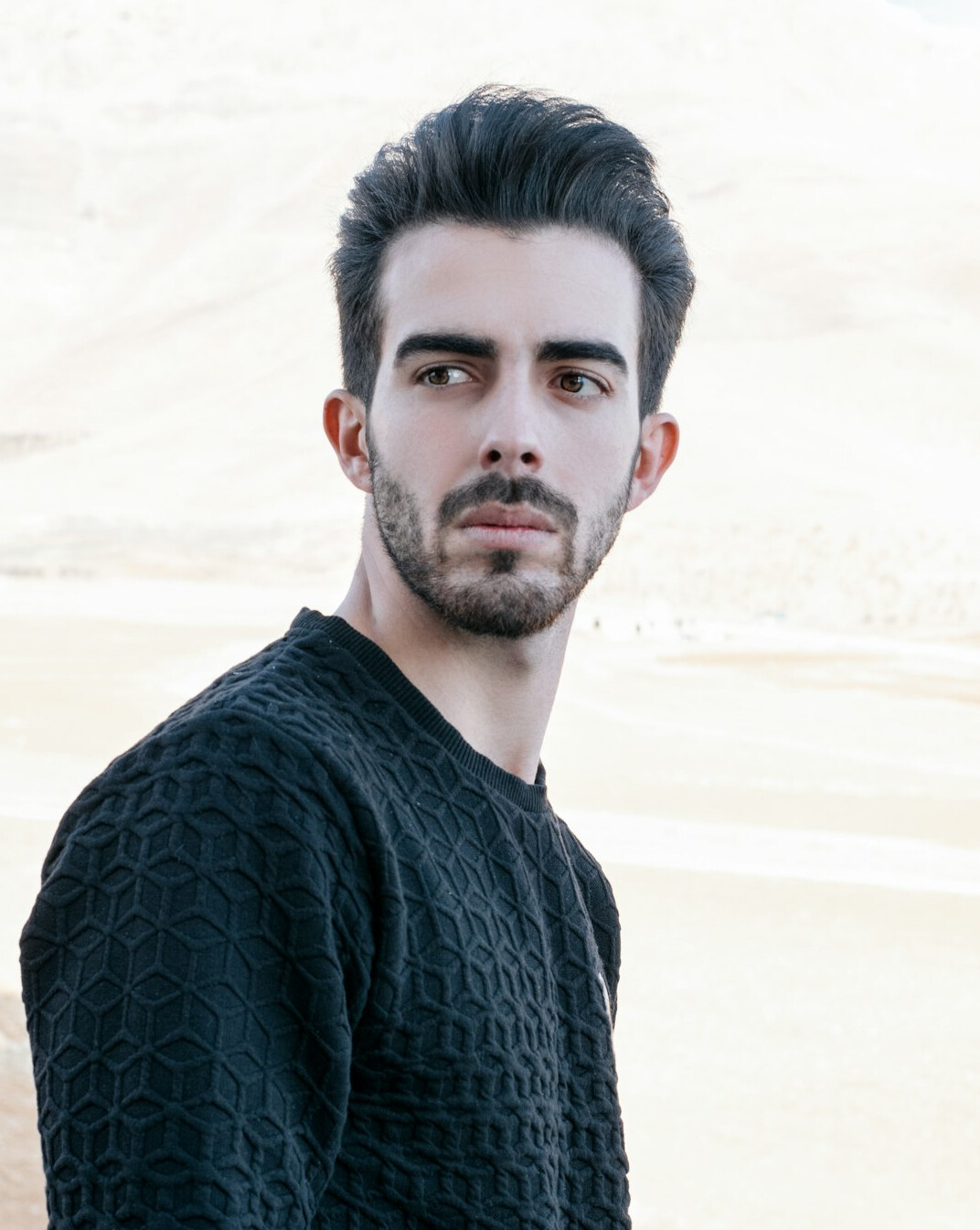 Portrait of a man with short dark hair and a light beard
