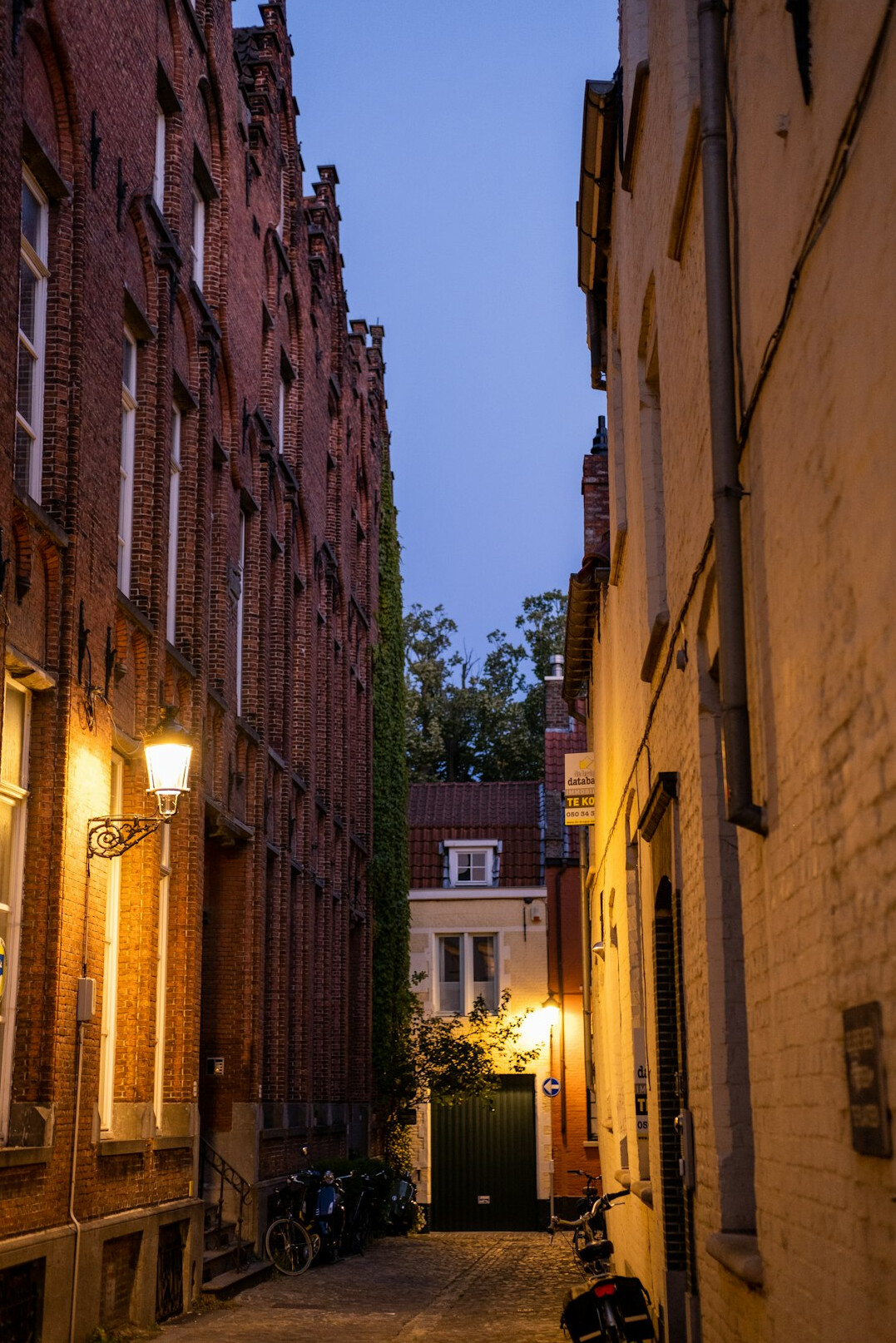 Narrow historic European street with old buildings at dusk