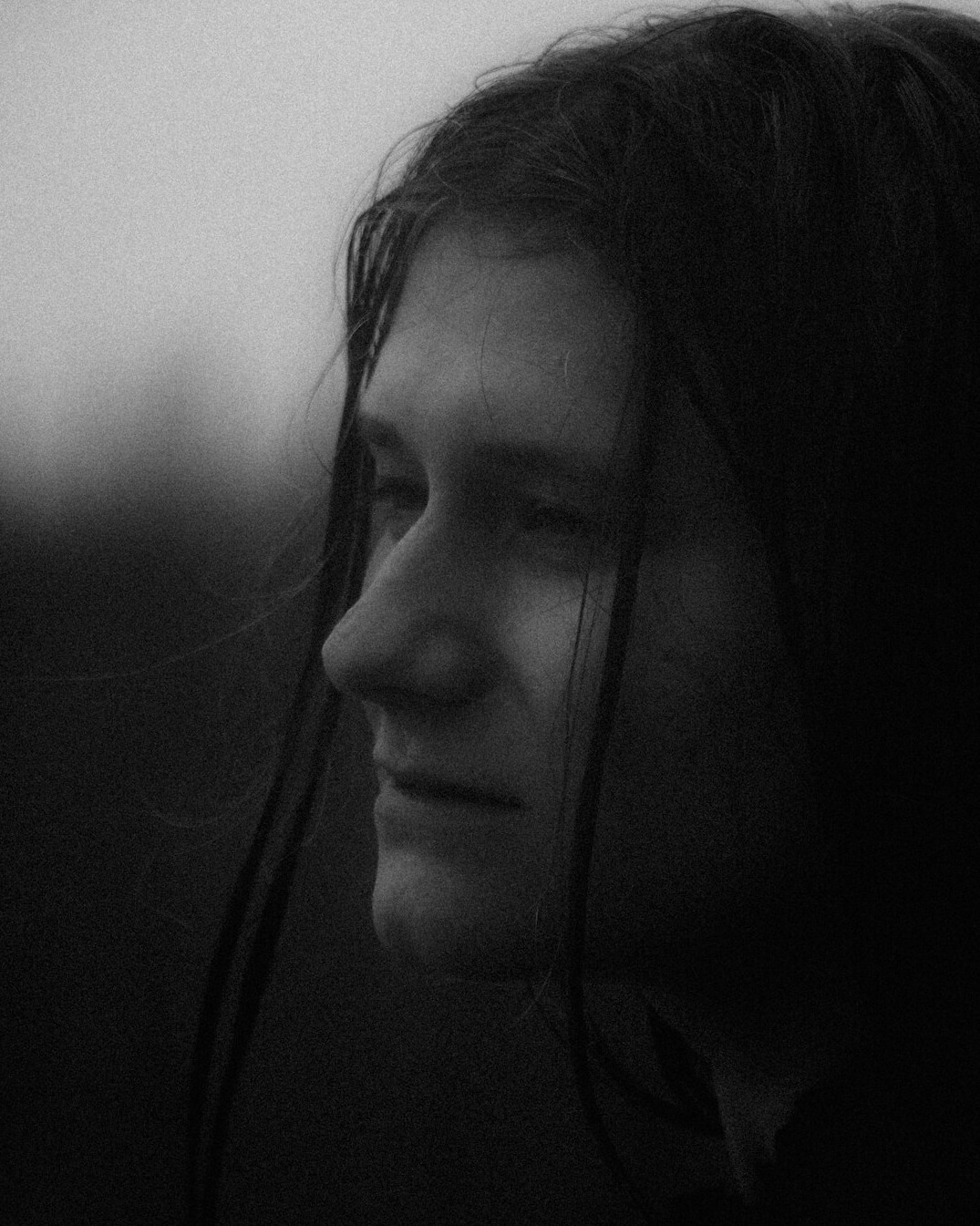 Portrait of a woman with long hair smiling softly