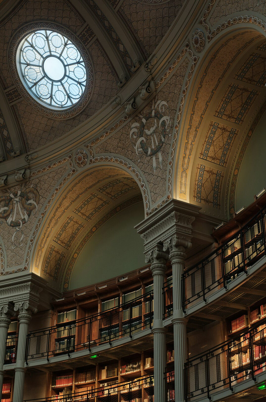 Historic library interior with tall wooden shelves and arched ceiling