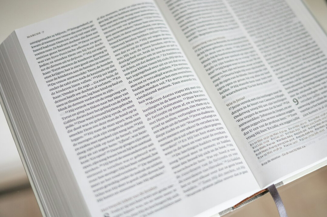 Open book with pages fanned out on a reading table